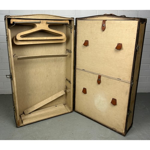 513 - A LARGE BEIGE TRAVEL WARDROBE TRUNK WITH FITTED INTERIOR