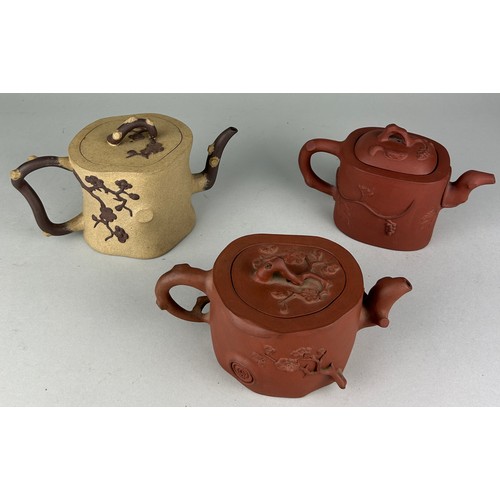 154 - A COLLECTION OF THREE CHINESE YIXING CLAY TEAPOTS (3) 

Of unusual shape and naturalistic form, with...