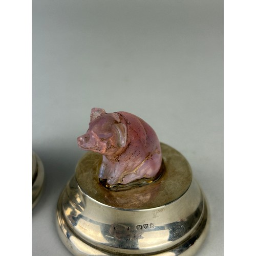 65 - A PAIR OF PINK QUARTZ CRYSTAL PIGS MOUNTED ON SILVER DESK WEIGHTS, 

With red leather bases.

6.5cm ... 