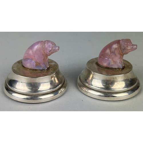 65 - A PAIR OF PINK QUARTZ CRYSTAL PIGS MOUNTED ON SILVER DESK WEIGHTS, 

With red leather bases.

6.5cm ... 