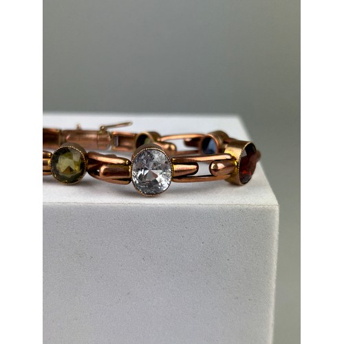 31 - A 9CT GOLD BRITTANIC BRACELET,

Weight: 14.4gms, set with semi precious stones.