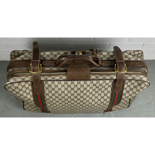 359A - GUCCI LUGGAGE: A VINTAGE GUCCI SUITCASE,

Gucci monogram throughout with brown stitched leather stra... 