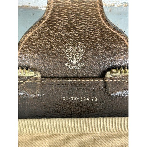359A - GUCCI LUGGAGE: A VINTAGE GUCCI SUITCASE,

Gucci monogram throughout with brown stitched leather stra... 