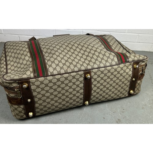 359A - GUCCI LUGGAGE: A VINTAGE GUCCI SUITCASE,

Gucci monogram throughout with brown stitched leather stra... 
