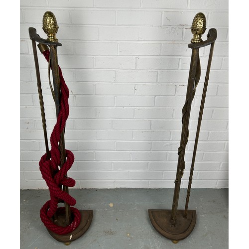 525 - TWO METAL ROPE STANCHIONS, with brass pine cone detail and red rope, 106cm h (each)



Used conditio... 