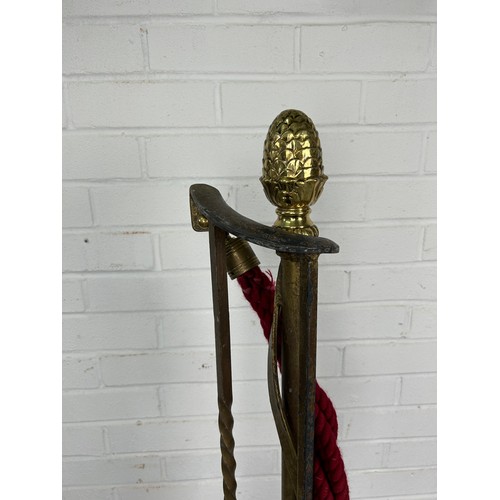 525 - TWO METAL ROPE STANCHIONS, with brass pine cone detail and red rope, 106cm h (each)



Used conditio... 