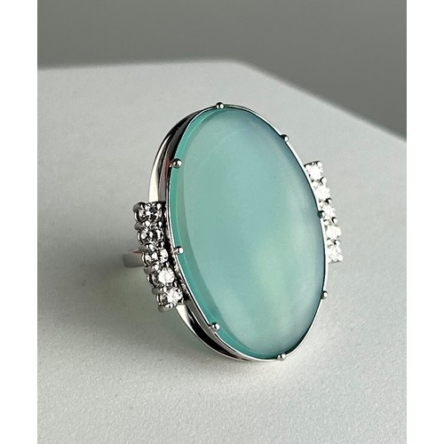 1 - AN OVAL CABOCHON CUT NATURAL CHRYSOCOLLA-IN-CHALCEDONY FROM THE INSPIRATION MINE AND TEN (10) ROUND ... 