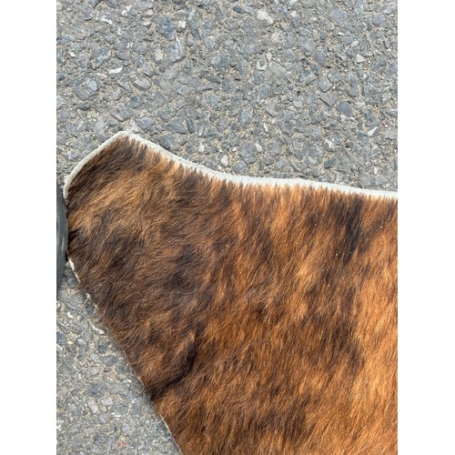 556 - A LARGE COW HIDE RUG,

190cm x 180cm