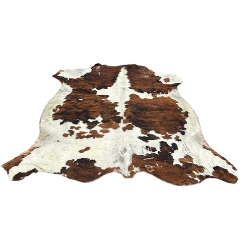 557A - A LARGE COW HIDE RUG,

210cm x 200cm