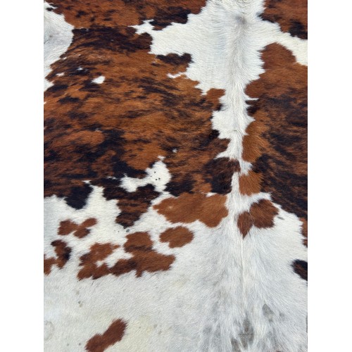 557A - A LARGE COW HIDE RUG,

210cm x 200cm