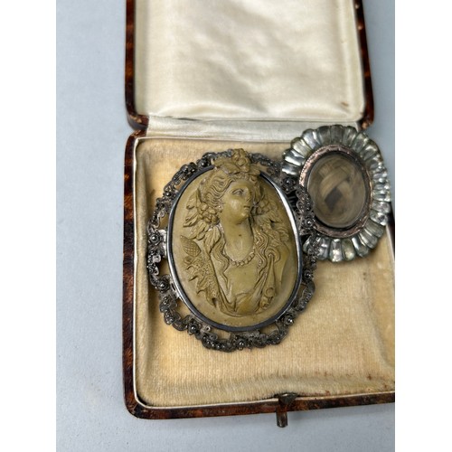 49A - A CARVED CAMEO BROOCH DEPICTING A LADY ALONG WITH A 19TH CENTURY MOURNING BROOCH,

Both housed in an... 