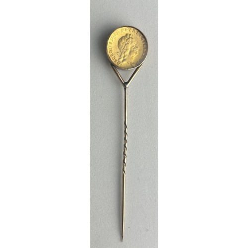 75 - A GEORGE I GOLD QUARTER GUINEA 1718, 

Mounted on a gold pin between glass.

Weight: 5.2gms