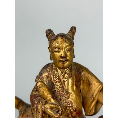 118 - A CHINESE RED LACQUERED AND GILT WOOD FIGURE RIDING A LION, 

21cm x 19cm