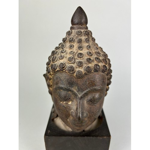 120 - A BRONZE SCULPTURE OF A BUDDHA'S HEAD, 

Later mounted on a wooden base. 

The head 17cm. Total heig... 