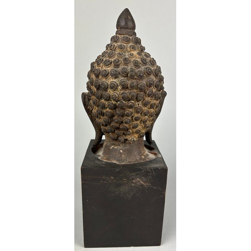 120 - A BRONZE SCULPTURE OF A BUDDHA'S HEAD, 

Later mounted on a wooden base. 

The head 17cm. Total heig... 