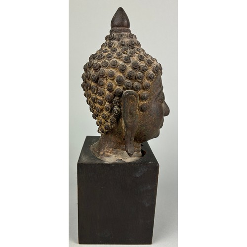 120 - A BRONZE SCULPTURE OF A BUDDHA'S HEAD, 

Later mounted on a wooden base. 

The head 17cm. Total heig... 