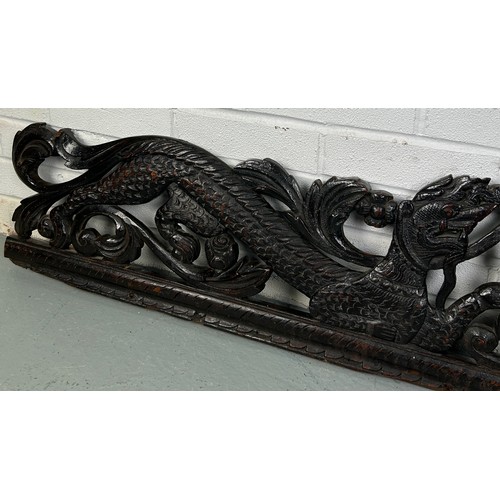 151 - A LARGE CARVED PANEL WITH DRAGONS, POSSIBLY CHINESE ROSEWOOD 19TH CENTURY

158cm x 28cm