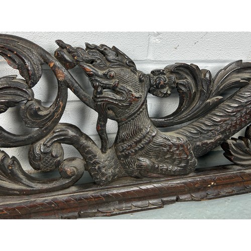 151 - A LARGE CARVED PANEL WITH DRAGONS, POSSIBLY CHINESE ROSEWOOD 19TH CENTURY

158cm x 28cm