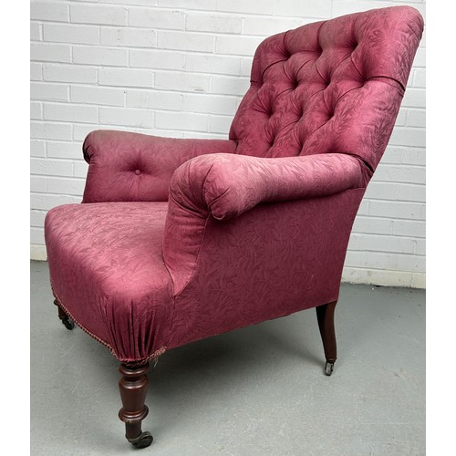 279 - A VICTORIAN BUTTON BACK ARMCHAIR IN THE MANNER OF HOWARD AND SONS, 

Upholstered in raspberry colour... 