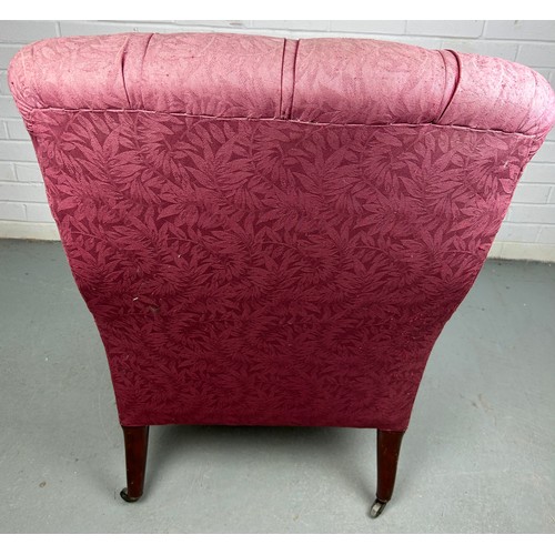 279 - A VICTORIAN BUTTON BACK ARMCHAIR IN THE MANNER OF HOWARD AND SONS, 

Upholstered in raspberry colour... 