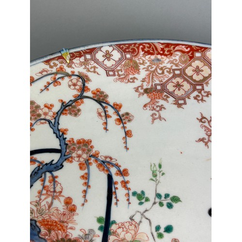 149 - AN EXCEPTIONALLY LARGE AND FINE JAPANESE IMARI PLATE DECORATED WITH LACQUERED FURNITURE AND BASKETS ... 