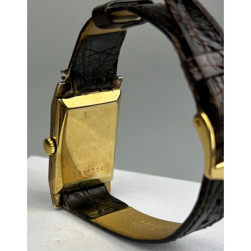 68 - A GENEVE WRISTWATCH MARKED 585, 

With brown leather strap.