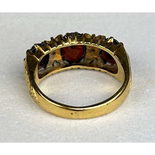 82 - AN ANTIQUE 18CT GOLD RING SET WITH THREE GARNETS, 

Weight: 6.69 gms

Ring size 12.