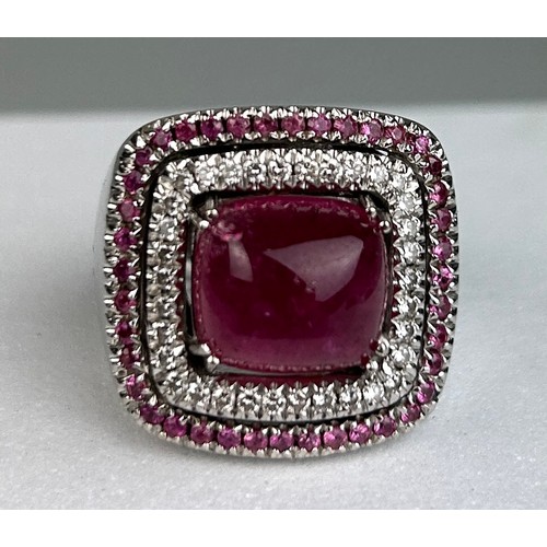 83 - AN 18CT WHITE GOLD RING SET WITH RUBELITE AND SMALL RUBIES, 

Signed. 

Weight: 22.7gms

Ring size 1... 