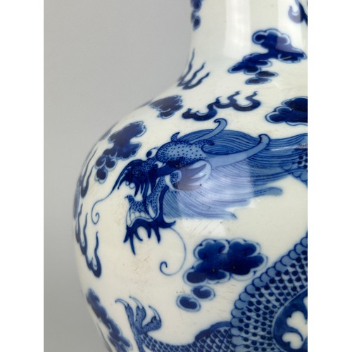 137 - A LARGE CHINESE BLUE AND WHITE VASE OF GLOBULAR DECORATED WITH DRAGONS, 

40cm x 20cm