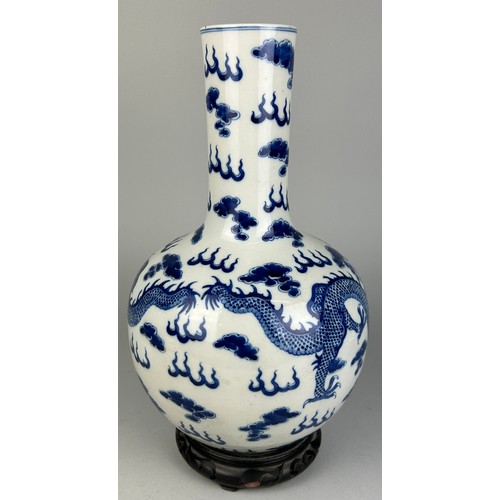 137 - A LARGE CHINESE BLUE AND WHITE VASE OF GLOBULAR DECORATED WITH DRAGONS, 

40cm x 20cm