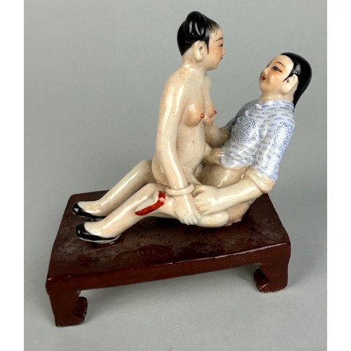 113 - A CHINESE EROTIC CERAMIC GROUP DEPICTING MALE AND FEMALE FIGURES,

12cm x 10cm x 6cm