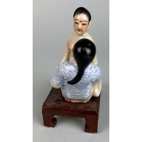 113 - A CHINESE EROTIC CERAMIC GROUP DEPICTING MALE AND FEMALE FIGURES,

12cm x 10cm x 6cm