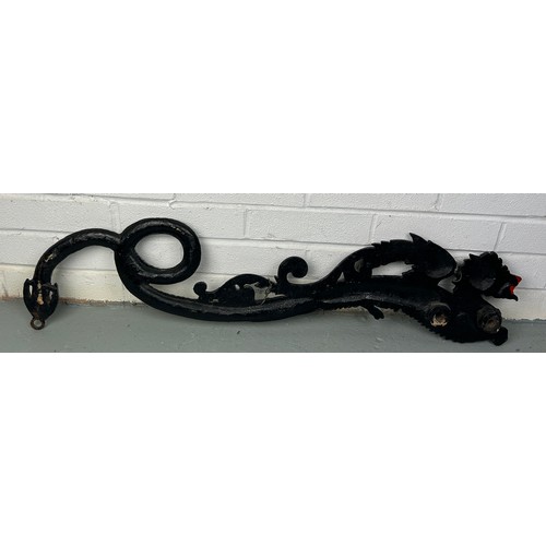 152 - A CHINESE WALL HANGING BLACK PAINTED METAL DRAGON,

90cm x 17cm