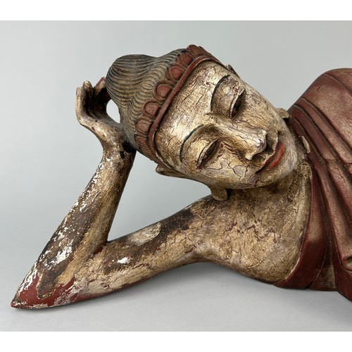 88 - A THAI CARVED WOODEN SCULPTURE OF THE RECLINING BUDDHA, 

20th Century

105cm x 23cm