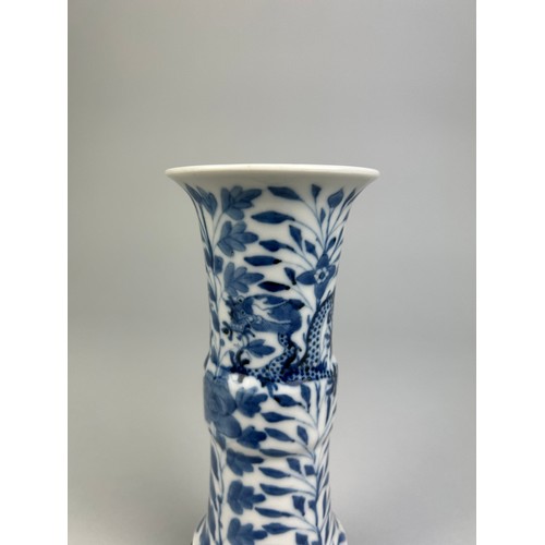 64 - A CHINESE BLUE AND WHITE VASE OF GU FORM, 

Depicting a four clawed dragon amongst foliage.

15cm H