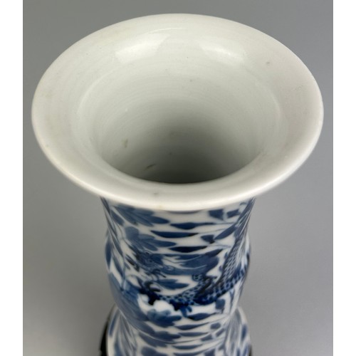 64 - A CHINESE BLUE AND WHITE VASE OF GU FORM, 

Depicting a four clawed dragon amongst foliage.

15cm H