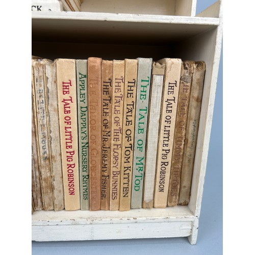 316 - A COLLECTION OF 29 PETER RABBIT BOOKS WITH ORIGINAL PETER RABBITS BOOK CASE CIRCA 1940

29 books in ... 