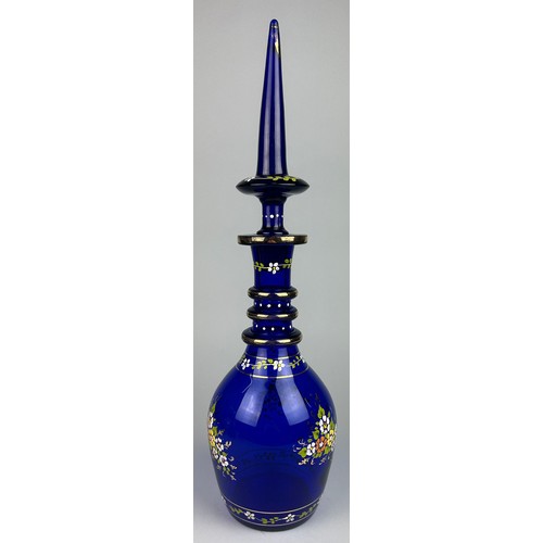 324 - A LARGE BLUE BOHEMIAN GLASS DECANTER GILT DECORATED WITH FLOWERS,

53cm x 14cm