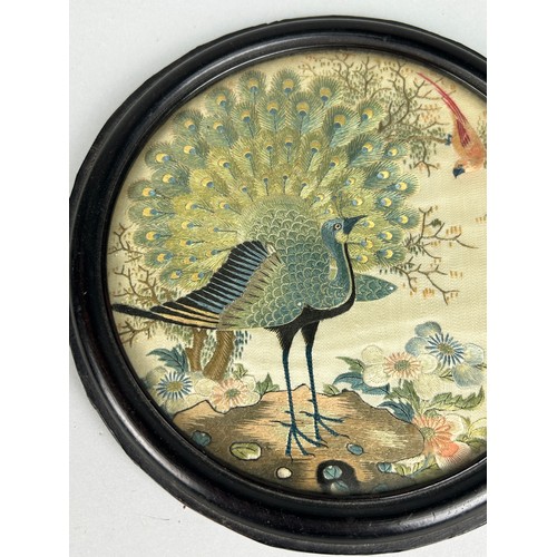 92 - A 19TH CENTURY CHINESE CIRCULAR SILK PANEL DEPICTING A PEACOCK AMONGST FOLIAGE, 

15cm in diameter 
... 