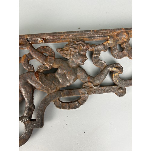 507 - APAIR OF IRON CORNER BRACKETS WITH CHERUBS,  

37cm X 25cm each