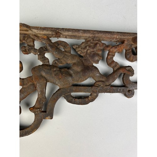 507 - APAIR OF IRON CORNER BRACKETS WITH CHERUBS,  

37cm X 25cm each