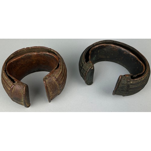 127 - TWO AFRICAN TRIBAL COPPER CURRENCY BANGLES POSSIBLE BOULE, 

Total weight: 1295gms 

Largest 12cm x ... 