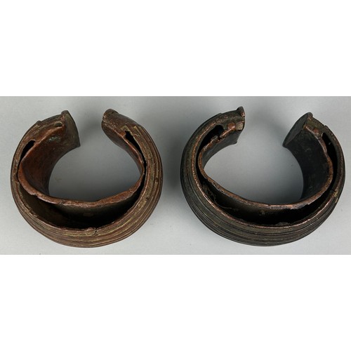 127 - TWO AFRICAN TRIBAL COPPER CURRENCY BANGLES POSSIBLE BOULE, 

Total weight: 1295gms 

Largest 12cm x ... 