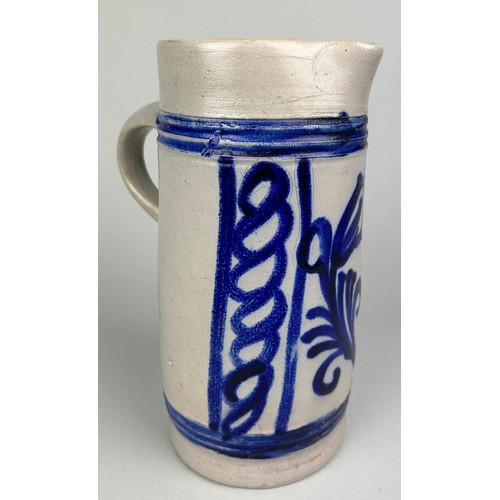 353 - A GERMAN SALT GLAZD EARTHENWARE JUG, 

Blue painted design. 

23cm H