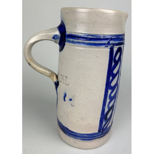 353 - A GERMAN SALT GLAZD EARTHENWARE JUG, 

Blue painted design. 

23cm H