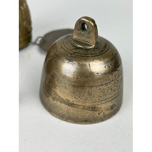 358 - THREE SOUTH EAST ASIAN BRASS OR BRONZE BELLS AND ANOTHER UNRELATED (4)