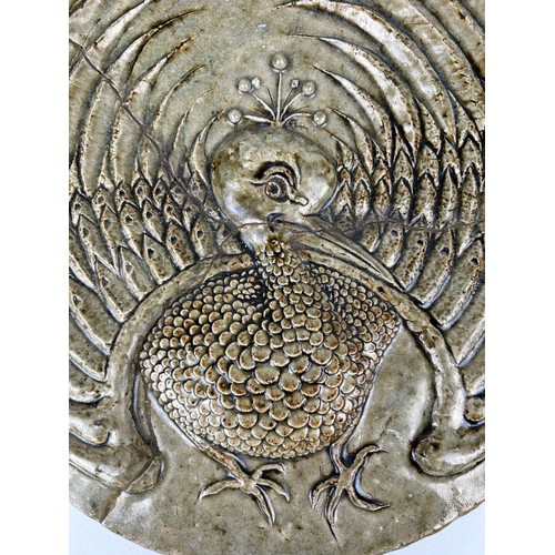 351 - IN THE MANNER OF MARTIN BROTHERS: A LARGE PLAQUE DEPICTING A BIRD WITH FANNED WINGS, 

32cm D

Old r... 