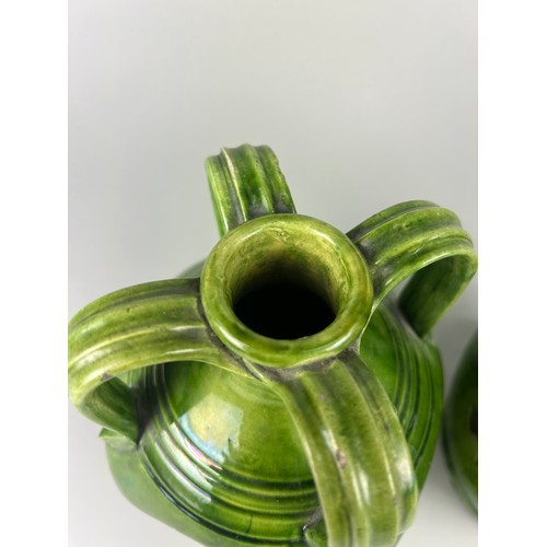 355 - A PAIR OF ART NOUVEAU FOUR HANDLED GREEN GLAZED LUSTRE CERAMIC JUGS, 

24cm x 15cm