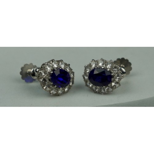 203A - A PAIR OF WHITE METAL EARRINGS WITH BLUE STONES AND POSTS MARKED 9CT,