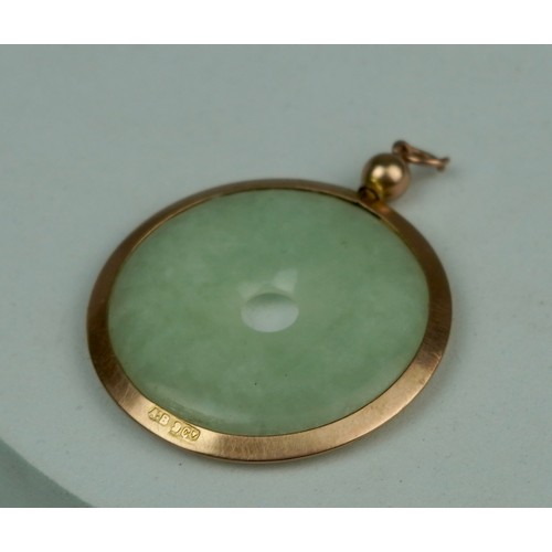 159 - A CHINESE JADE BI SET IN 9CT GOLD, 

In Goldsmiths and Silversmiths Company case. 

Weight: 8.55gms ... 